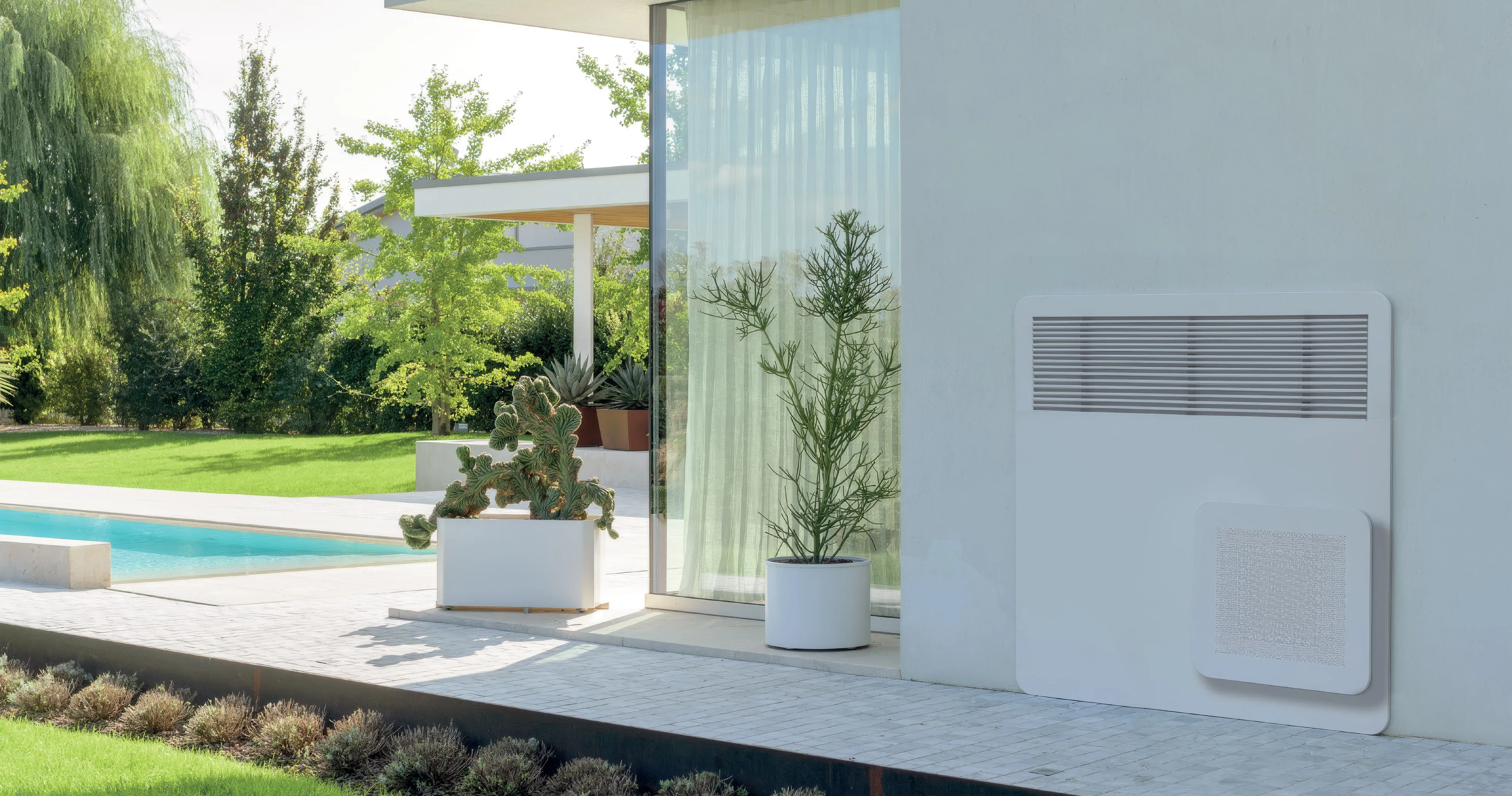 A STØNE wall-mounted unit on a modern poolside terrace