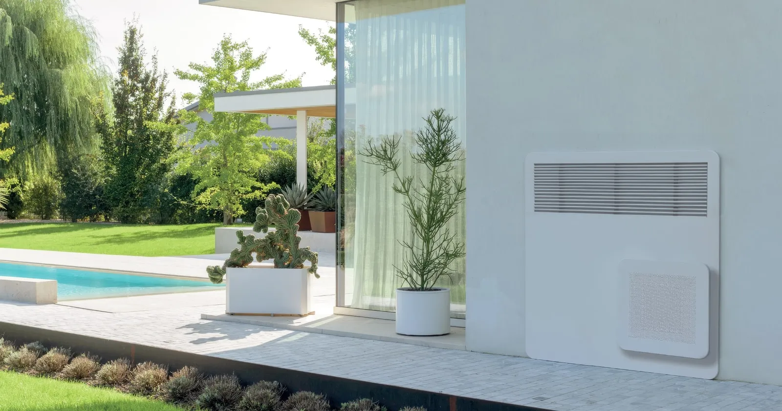 A STØNE wall-mounted unit on a modern poolside terrace