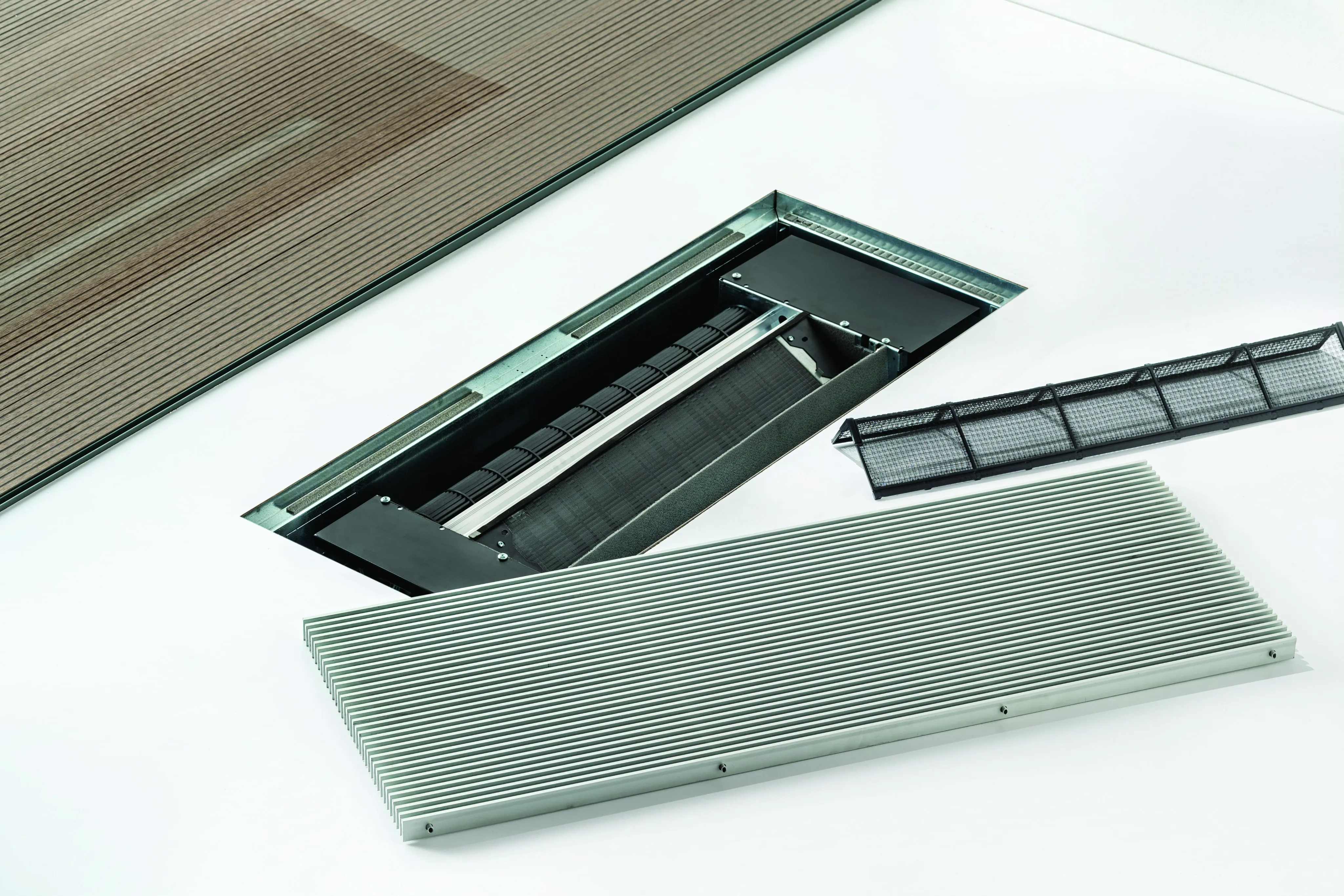 An OSMO frameless trench unit disassembled beside its floor housing