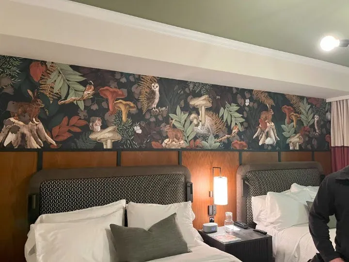A guest room at The SOMM with a soffit running above the headboards, concealing the HVAC unit